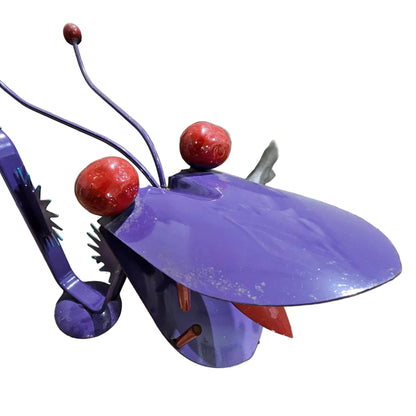 Purple and red decorative object on a concrete surface