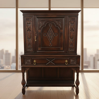 Decorative wooden cabinet with intricate carvings in a room setting.
