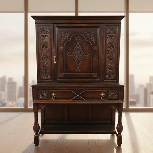 Decorative wooden cabinet with intricate carvings in a room setting.
