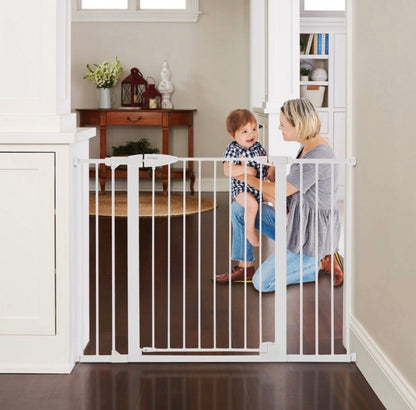 Woman and child behind a white baby gate in a home setting